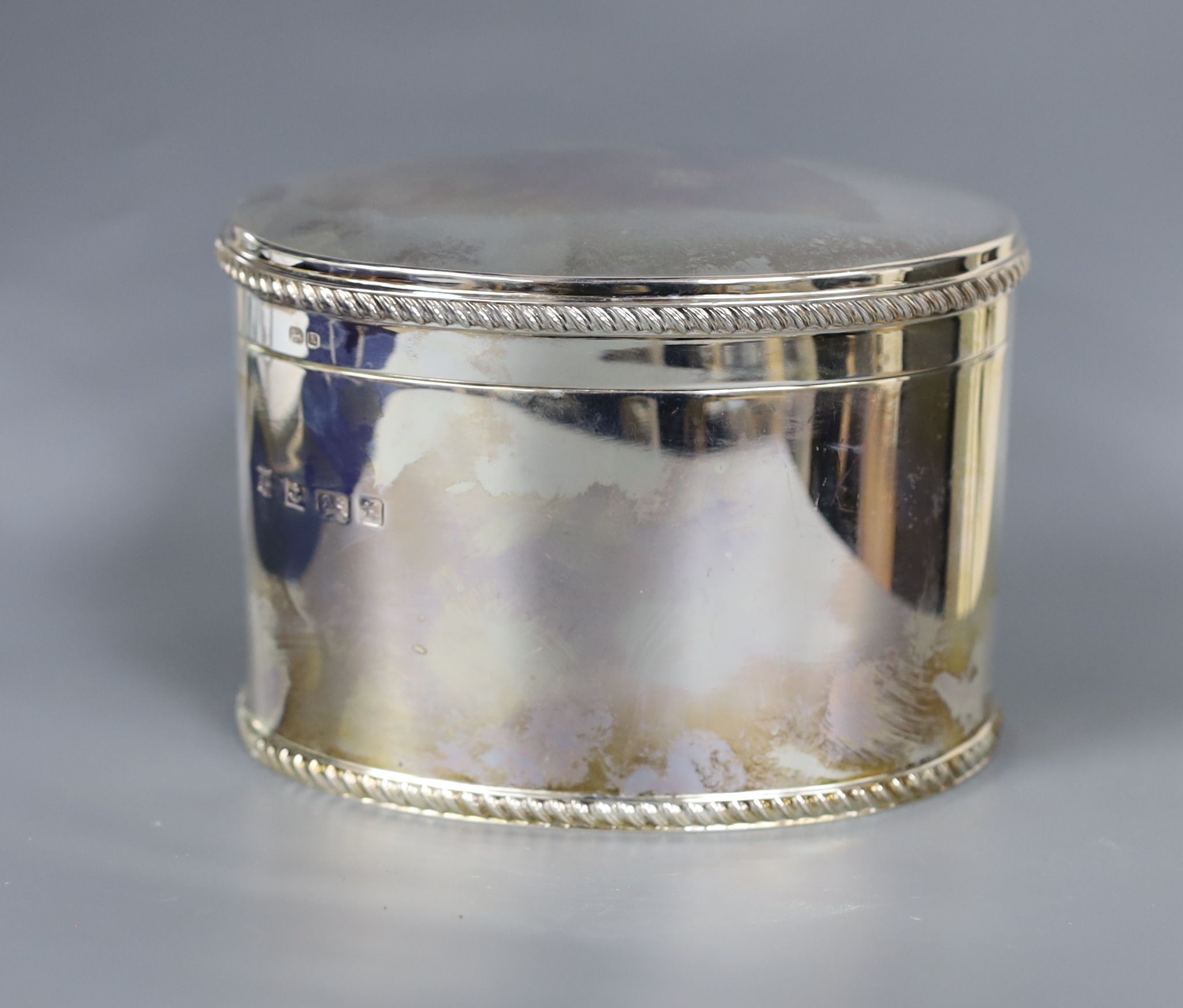 A cased modern silver oval tea caddy, Barker Ellis Silver Co. Birmingham, 1997, length 14cm, 18.5oz, in Gallagher box.